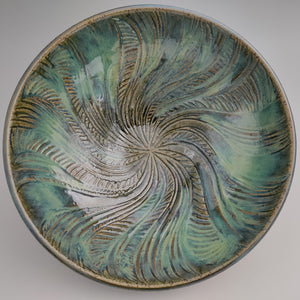 Decorative green bowl with spiral sun