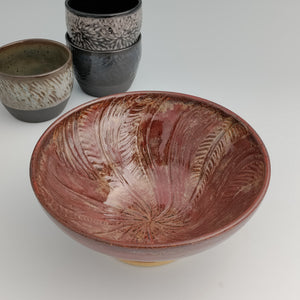 Red bowl with spiral sun