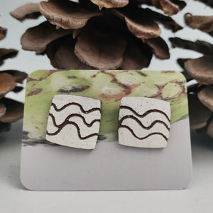 Square studs with squiggles